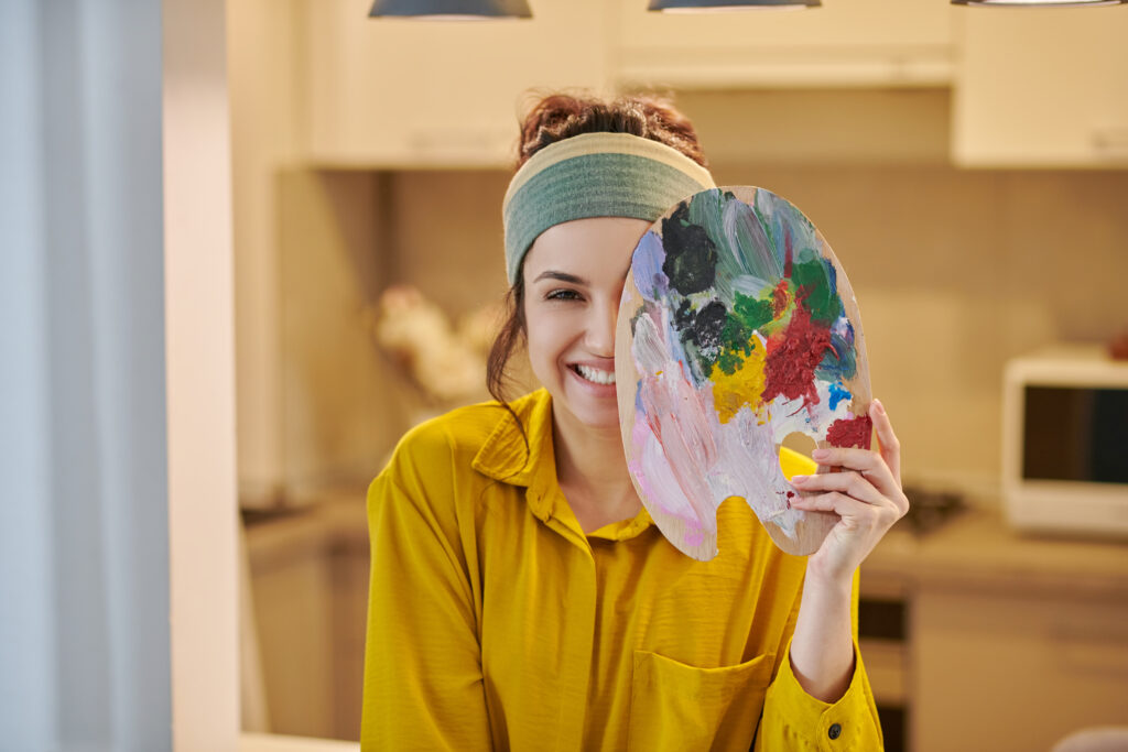 Cute female artist looking happy and enjoyed