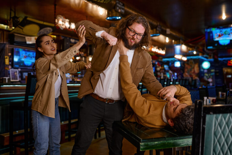 Young woman trying to separate craze mad fighting friends